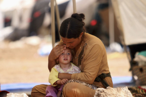 A woman who fled the Islamic State's strongholds of Hawija and Mosul, cares for her baby at a camp for displaced people in Daquq, Iraq,  <br/>Reuters