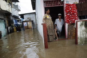 A Sri Lankan family looks out from their flooded home in Colombo, Sri Lanka, Monday, May 17, 2010. Heavy monsoon showers caused floods in many parts of the country. <br/>AP Photo / Eranga Jayawardena