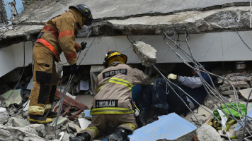 Rescue workers search the rubble of a collapsed building for victims in Guayaquil, Ecuador, on April 17. (Luis Acosta/AFP/Getty Images) <br/>