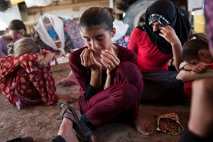 The Islamic State terrorist group executed a pregnant woman and took away her four children after they tried to flee their village in Iraq, a horrific new report has revealed. Over the past two years, thousands of Yazidi and Christian women in the Middle East have experienced extreme brutality at the hands of Islamic State militants, prompting US Secretary of State John Kerry to class such atrocities as ''genocide.'' Photo Credit: Reuters <br/>