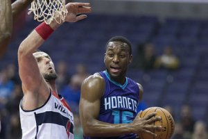 Kemba Walker of the Charlotte Hornets drives against Marcin Gortat of the Washington Wizards during a preseason game at the Verizon Center on October 17, 2014 in Washington, D.C. <br/>Flickr/Keith Allison