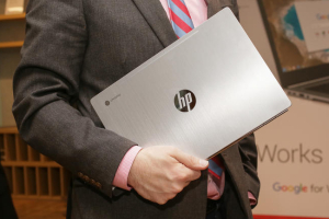 A man carrying HP's Chromebook 13  <br/>CNET