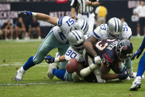 Houston Texans' Arian Foster fumbles while being tackled by Dallas Cowboys' Keith Brooking, Jay Ratliff and Anthony Spencer. Reliant Stadium. Houston, Tx. Sept. 26 2010. <br/>Wikimedia Commons/AJ Guel