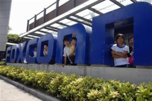 Workers stand at the gate of a Foxconn factory in the township of Longhua in Shenzhen, Guangdong province May 26, 2010. <br/>