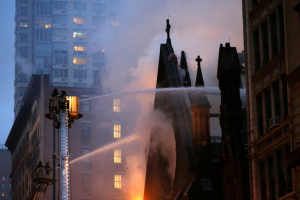 Firefighters at the 19th-century Serbian Orthodox Cathedral of St. Sava on Sunday. Credit Kathy Willens/Associated Press <br/>