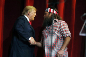 Willie Robertson welcomes Republican presidential candidate Donald Trump to the stage during the Outdoor Channel and Sportsman Channel's 16th annual Outdoor Sportsman Awards, Jan. 21, 2016, in Las Vegas.  Photo by Isaac Brekken/AP <br/>