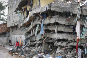 Residents walk next to a collapsed building in Nairobi, Kenya,  <br/>Rappler
