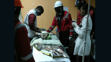 A baby girl receives treatment after being rescued from the rubble of a building in Nairobi. <br/>