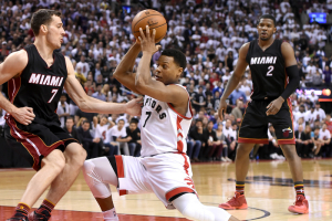 May 5, 2016; Toronto, Ontario, CAN; Toronto Raptors guard Kyle Lowry (7) cuts between Miami Heat guard Goran Dragic (7) and forward Joe Johnson (2) in game two of the second round of the NBA Playoffs at Air Canada Centre. The Raptors won 96-92.  <br/>Dan Hamilton-USA TODAY Sports