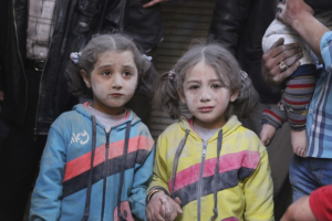 Girls who survived what activists said was a ground-to-ground missile attack by forces of Syria's President Bashar al-Assad, hold hands at Aleppo's Bab al-Hadeed district April 7, 2015. REUTERS/Abdalrhman Ismail <br/>