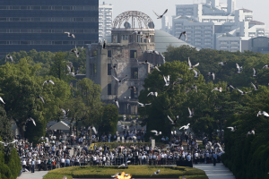 Doves fly over the Peace Memorial Park with the Atomic Bomb Dome in the background, at a ceremony in Hiroshima, western Japan, August 6, 2015, on the 70th anniversary of the atomic bombing of the city. REUTERS/Toru Hanai <br/>