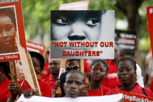 Bring Back Our Girls (BBOG) campaigners hold banners as they walk during a protest procession marking the 500th day since the abduction of girls in Chibok, along a road in Lagos August 27, 2015. REUTERS/Akintunde Akinleye <br/>