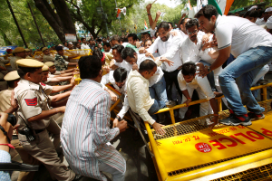 Supporters of Congress party break police barricades during what the party calls as a 