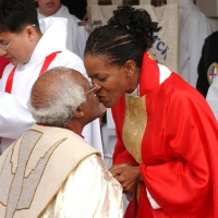 Rev. Canon Mpho Tutu-Van Furth kisses her father, Desmund Tutu, after having ordained priest at the Church of Christ in Alexandria in 2004. Desmund was archbishop of Cape Town that time. <br/>Photo: The Telegraph