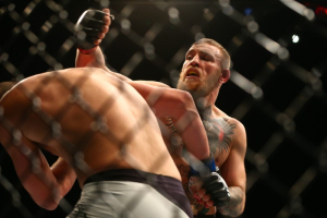 Las Vegas, NV, USA; Conor McGregor moves in for a punch against Nate Diaz during UFC 196 at MGM Grand Garden Arena. <br/>Mark J. Rebilas-USA TODAY Sports