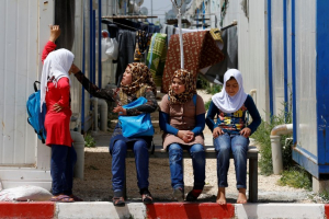 Syrian girls sit outside their container at Harran refugee camp in the Sanliurfa province, Turkey April 26, 2016.  <br/>REUTERS/Umit Bektas