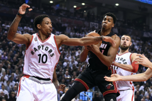 Toronto, Ontario, CAN; Miami Heat center Hassan Whiteside (21) grabs a rebound between Toronto Raptors guard DeMar DeRozan (10) and center Jonas Valanciunas (17) in game two of the second round of the NBA Playoffs at Air Canada Centre. <br/>Dan Hamilton-USA TODAY Sports