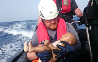A German rescuer carry the dead infant, believed to be six-month-old Somali, he and his team plucked out off the Libyan coast was among the hundreds of migrants that were drowned off Mediterranean waters last week. This photo by Reuters sparked international outraged. <br/>Photo: Reuters