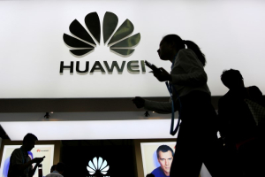 People walk past a sign board of Huawei at CES (Consumer Electronics Show) Asia 2016 in Shanghai, China May 12, 2016. REUTERS/Aly Song <br/>Reuters