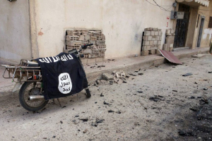 A flag belonging to the Islamic State fighters is seen on a motorbike after forces loyal to Syria's President Bashar al-Assad recaptured the historic city of Palmyra, in Homs Governorate in this handout picture provided by SANA on March 27, 2016. <br/>REUTERS/SANA/Handout via Reuters