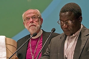 Mennonite World Conference President Danisa Ndlovu of Zimbabwe, right, presents Lutheran World Federation (LWF) President Bishop Mark. S. Hanson with a pine foot-washing tub as a sign of commitment to a future <br/>LWF / Erick Coll