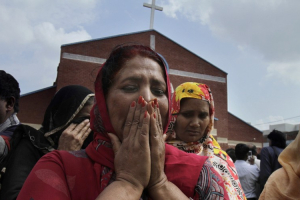 A Pakistani Christian mourns as people gather at a church attacked by a suicide bomber. <br/>Reuters