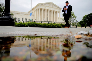 A pedestrian walks in front of the U.S. Supreme Court building in Washington, U.S. May 19, 2016.  <br/>REUTERS/Carlos Barria