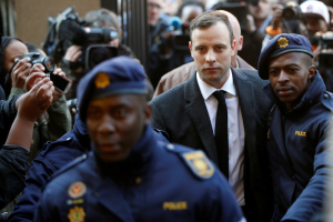 Olympic and Paralympic track star Oscar Pistorius is escorted by police officers as he arrives for his sententencing for the 2013 murder of his girlfriend Reeva Steenkamp, at North Gauteng High Court in Pretoria, South Africa July 6, 2016.  <br/>REUTERS/Siphiwe Sibeko
