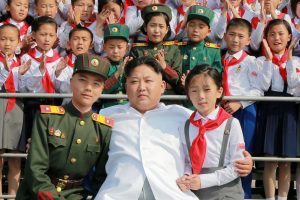 Schoolchildren stand beside North Korean leader Kim Jong Un as he arrives to attend 