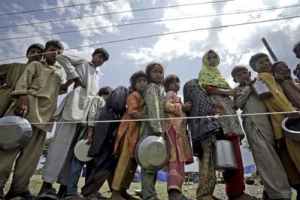 Pakistani flood survivors line up for food in a camp set up for displaced people in Nowshera, Pakistan on Tuesday, Aug. 24, 2010. <br/>AP Images / Mohammad Sajjad