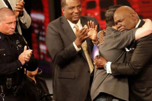 T.D. Jakes embraces a first responder during a service, Sunday in Dallas, that included a memorial to the five police officers gunned down during a protest in the city on Thursday. <br/>AP Photo