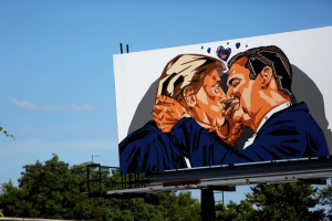 A billboard erected in advance of the Republican National Convention depicts U.S. Republican presidential candidate Donald Trump kissing former presidential candidate Sen. Ted Cruz (R-TX) in Cleveland, Ohio July 15, 2016.  <br/>REUTERS/Aaron P. Bernstein