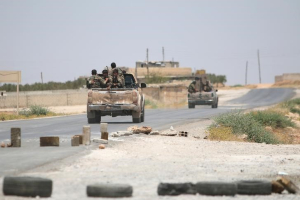 Syria Democratic Forces (SDF) ride vehicles along a road near Manbij, in Aleppo Governorate, Syria, June 25, 2016. <br/> REUTERS/Rodi Said/Files