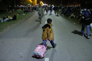 A migrant child crosses the street with a luggage in Tovarnik, Croatia, September 17, 2015.  <br/>REUTERS/Antonio Bronic