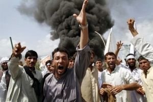 Afghans shout anti-U.S. slogans as they burn tires and block a highway during a protest in reaction to a small American church's plan to burn copies of the Quran, at Jalalabad, east of Kabul, Afghanistan, Friday, Sept. 10, 2010. Religious and political leaders across the Muslim world welcomed a decision by the church to suspend its plans to torch copies of their holy book but some said Friday the damage has already been done. <br/>AP Photo / Rahmat Gul