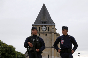 French CRS police stand guard in front of the church a day after a hostage-taking in Saint-Etienne-du-Rouvray near Rouen in Normandy, France, where French priest, Father Jacques Hamel, was killed with a knife and another hostage seriously wounded in an attack on the church that was carried out by assailants linked to Islamic State.  <br/>REUTERS/Pascal Rossignol