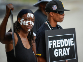 Angel Selah (L) and local artist PFK Boom gather to remember Freddie Gray and all victims of police violence during a rally outside city hall in Baltimore, Maryland, U.S., July 27, 2016.  <br/>REUTERS/Bryan Woolston