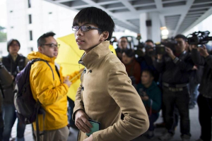 Joshua Wong pictured during pro-democracy protests in 2014. During the protests, activists used umbrellas to take cover from pepper spray fired by riot police.  <br/> Bobby Yip/Reuters