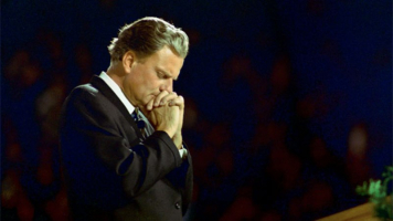 Rev. Billy Graham suggests school students use other, creative ways to talk to God during school days, even though school-sponsored prayers have been prohibited for the past five decades. Shown here is a younger Graham, who has been evangelizing since the 1950s. <br/>Billy Graham Evangelistic Association 
