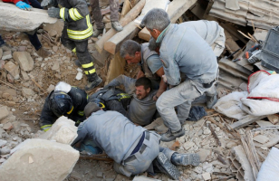 A man is rescued alive from the ruins following an earthquake in Amatrice, central Italy, August 24, 2016.  <br/>REUTERS/Remo Casilli