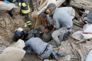 A man is rescued alive from the ruins following an earthquake in Amatrice, central Italy, August 24, 2016.  <br/>REUTERS/Remo Casilli