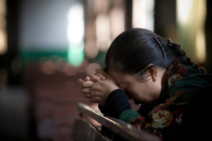 A Chinese woman prays during a church service in Pucheng, Shanxi. <br/>Getty Images