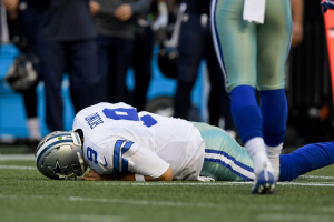 Aug 25, 2016; Seattle, WA, USA; Dallas Cowboys quarterback Tony Romo (9) lies on the field after he is tackled by Seattle Seahawks defensive end Cliff Avril (56) during the first half of an NFL football game at CenturyLink Field. <br/>Kirby Lee-USA TODAY Sports