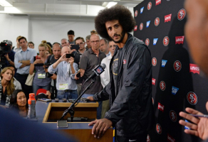Sep 1, 2016; San Diego, CA, USA; San Francisco 49ers quarterback Colin Kaepernick (center) talks to media after the game against the San Diego Chargers at Qualcomm Stadium. Mandatory Credit: Jake Roth-USA TODAY Sports <br/>