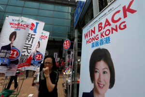 A woman walks past campaign banners of candidate Yung Hoi-yan from New People's Party on the election day of the Legislative Council in Hong Kong, China September 4, 2016.  <br/>REUTERS/Bobby Yip