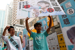 Nathan Law (L), candidate from Demosisto and student activist Joshua Wong greet supporters on election day for the Legislative Council in Hong Kong, China September 4, 2016.  <br/>REUTERS/Tyrone Siu