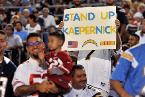San Diego, CA, USA; A San Diego Chargers fan holds up a sign in reference to San Francisco 49ers quarterback Colin Kaepernick (not pictured) during the first half of the game at Qualcomm Stadium. <br />
 <br/>Orlando Ramirez-USA TODAY Sports