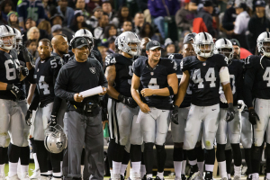 Oakland Raiders quarterback Derek Carr (4) smiles on the sideline with teammates during the fourth quarter against the Seattle Seahawks at Oakland Coliseum. The Seattle Seahawks defeated the Oakland Raiders 23-21.  <br/>Kelley L Cox-USA TODAY Sports