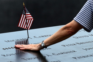 A woman places her hand over a name on the memorial at the National September 11 Memorial and Museum in Lower Manhattan in New York City, U.S., September 9, 2016.  REUTERS/Brendan McDermid <br/>