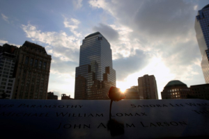 The sun peeks out over a rose that is placed on a name on the memorial at the National September 11 Memorial and Museum in Lower Manhattan in New York City, U.S., September 9, 2016. REUTERS/Brendan McDermid <br/>